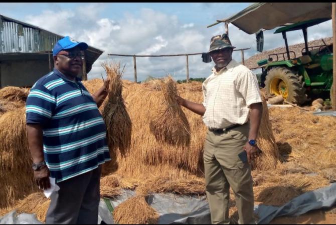 Acting Minister and Deputy Minister for Planning and Development Prof. Robert Fagans(R) with the farmer(L)
